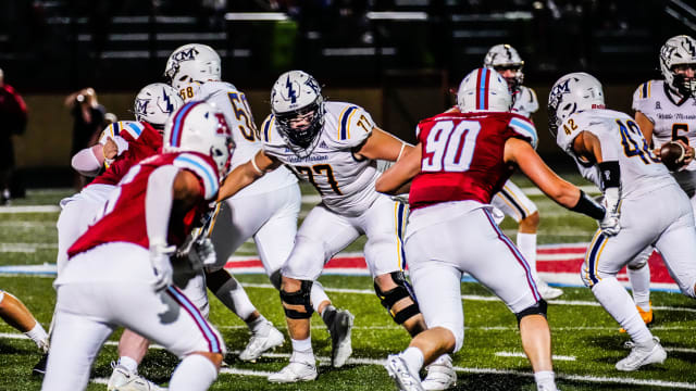 Kettle Moraine offensive lineman Brayden Thompson (77) holds off multiple defenders during the game at Arrowhead on Friday, Sept. 1, 2023.